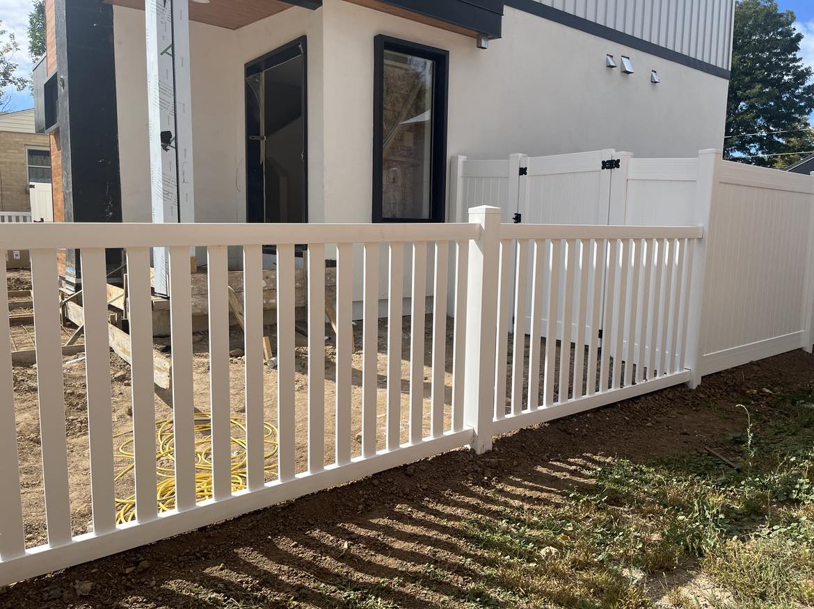 A white vinyl privacy fence