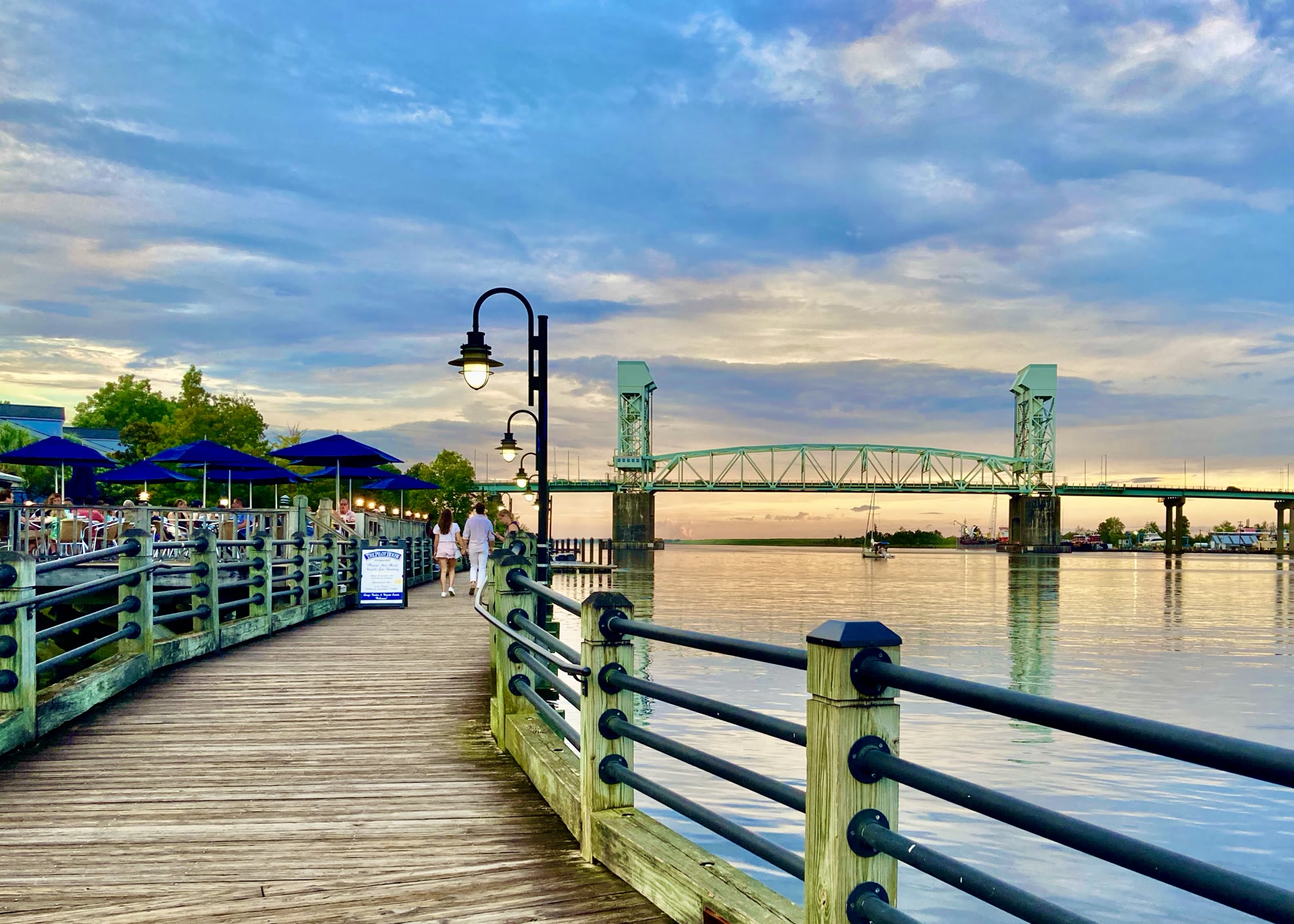 The Wilmington Riverwalk and Cape Fear Memorial Bridge at sunset